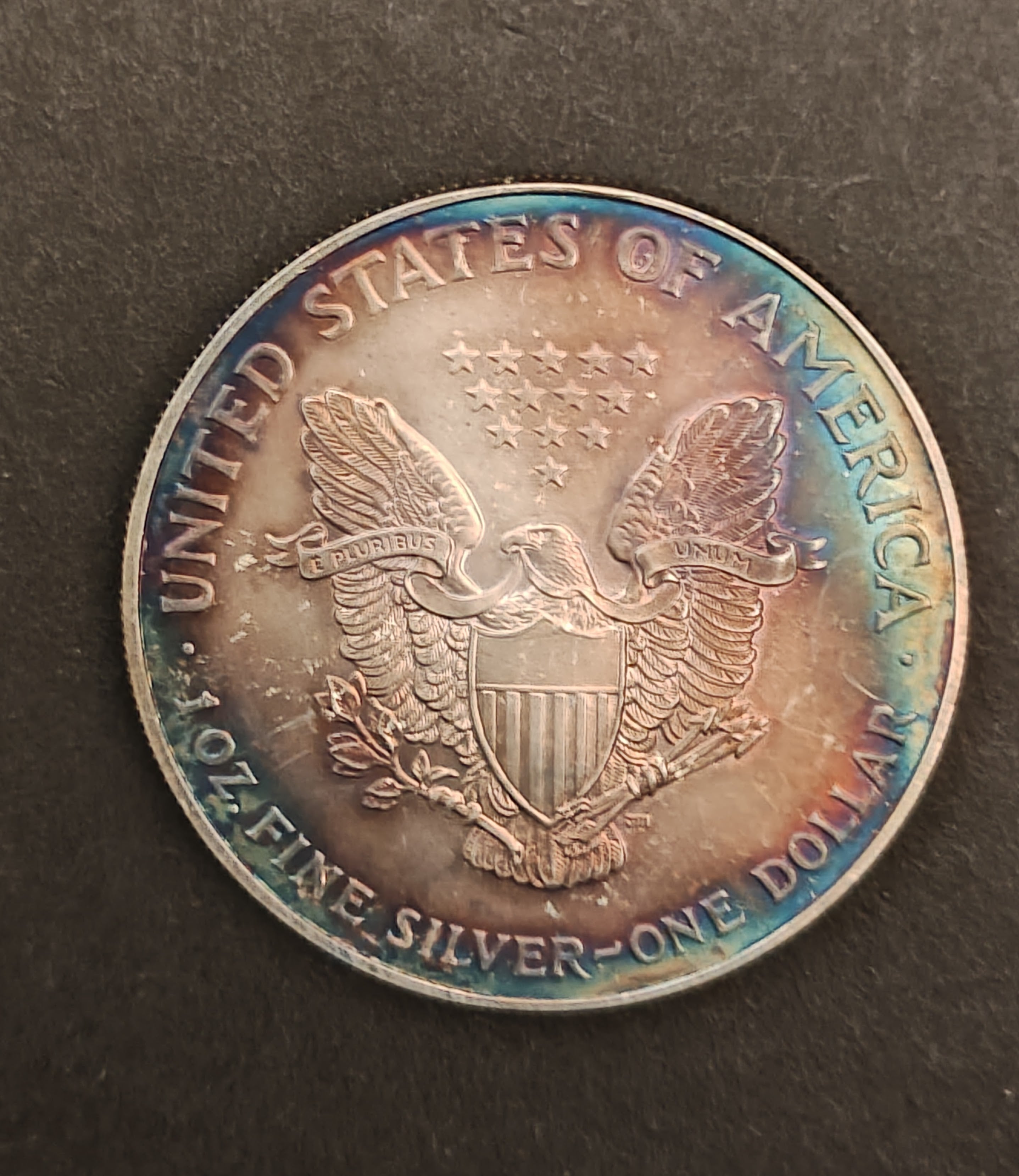 1 oz American Silver Eagle – Rainbow Toned with Minor Rim Marks